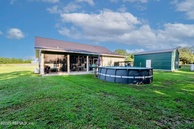 a view of a backyard with plants and a backyard