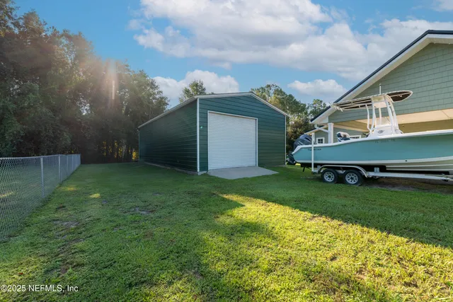 an aerial view of residential house with outdoor space and swimming pool