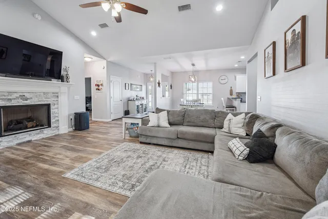 a living room with furniture and a wooden floor