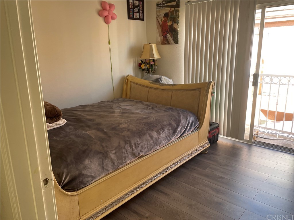 7267 Corbin Avenue, Unit B Winnetka, CA 91306 - Photo 6 of 8 a bed sitting in a bedroom next to a window