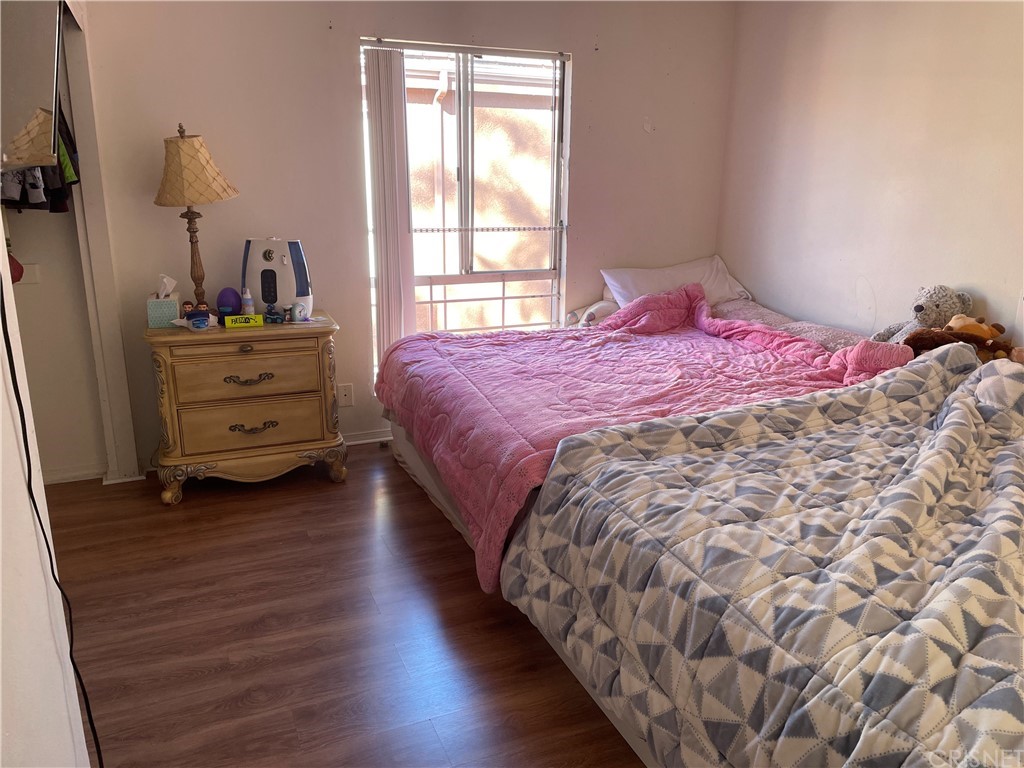 7267 Corbin Avenue, Unit B Winnetka, CA 91306 - Photo 8 of 8 a bedroom with a bed and a window