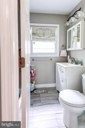 a bathroom with a toilet sink and window