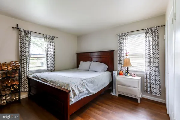 a bed sitting in a bedroom next to a window