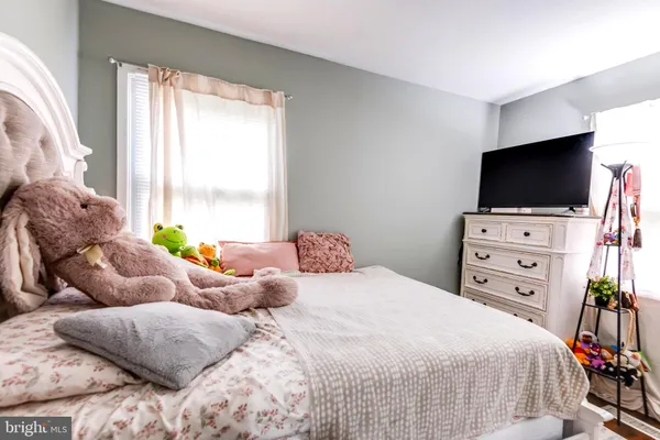 a bedroom with two beds and a flat screen tv