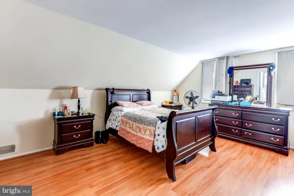 a bedroom with a bed and a dresser
