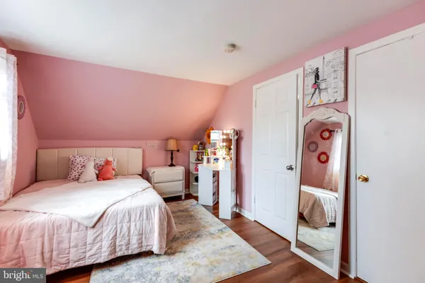 a bedroom with a bed and a mirror