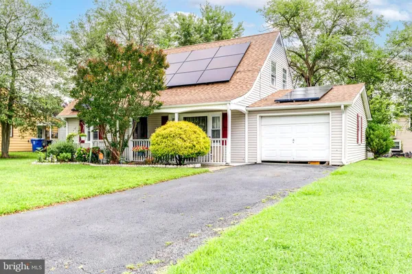 a view of a house with a yard and garage