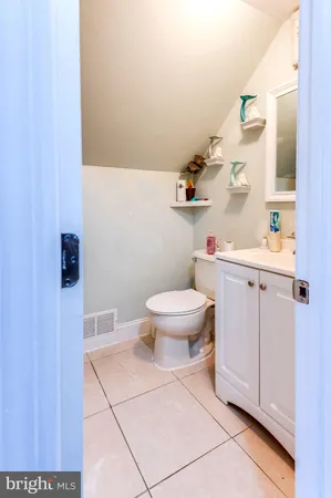 a bathroom with a toilet a sink and a window