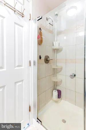 a bathroom with a tub shower and a sink