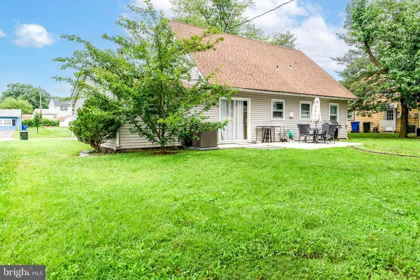 a view of a house with a yard and sitting area