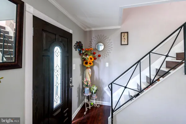 a view of entryway with wooden floor and stairs
