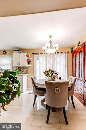 a view of a dining room with furniture and chandelier