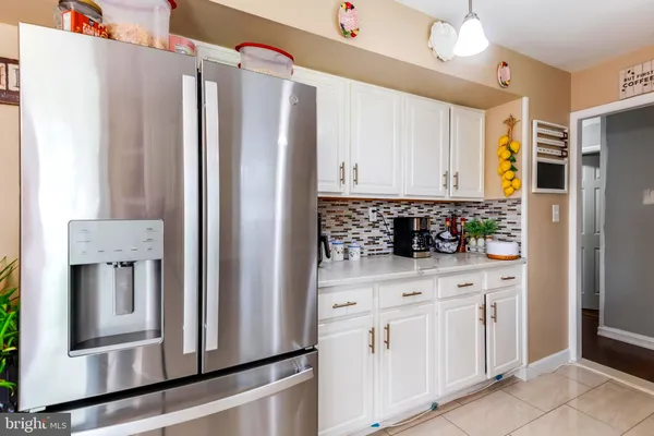 a kitchen with stainless steel appliances a refrigerator sink and cabinets