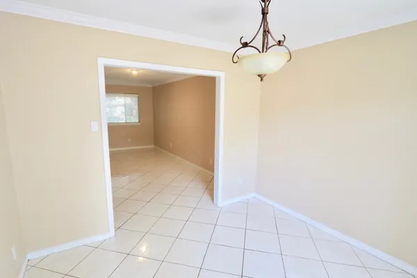 a view of a room with a chandelier fan and fire place