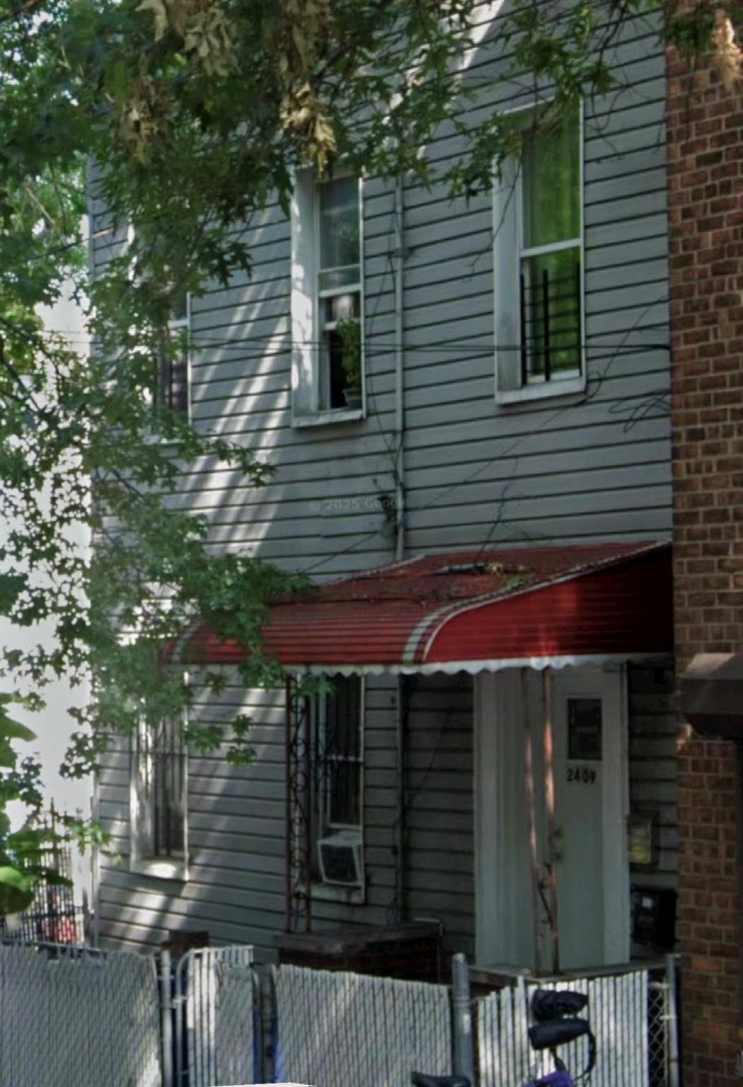 View of home's exterior with fence and cooling unit