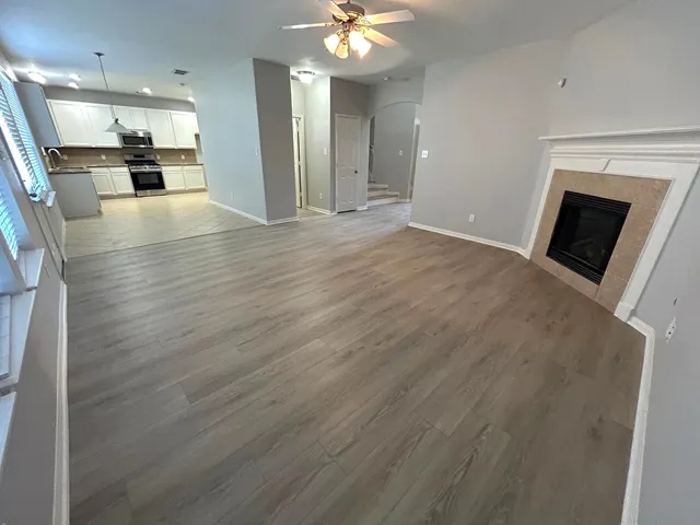 a view of an empty room with a fireplace