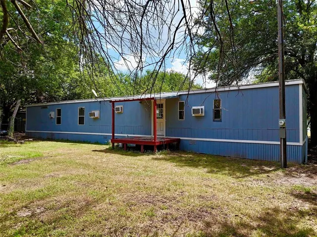 a view of a backyard with a large tree