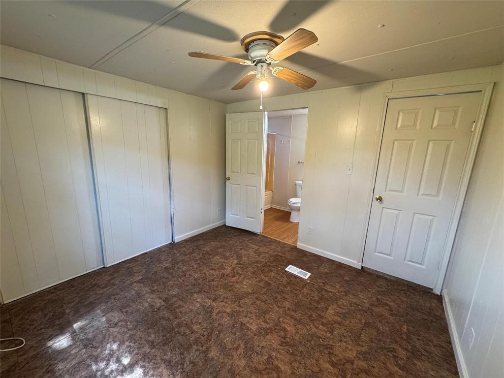 2010 Spring Court, Unit A Azle, TX 76020 - Photo 26 of 29 an empty room with closet and a chandelier fan
