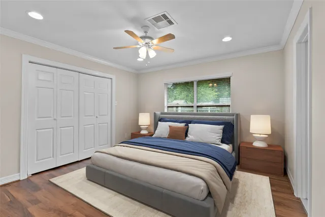 a bedroom with a large bed and a chandelier