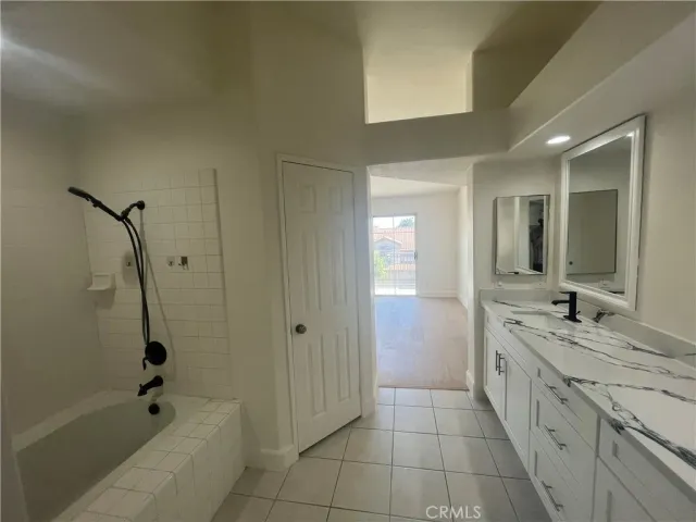 a spacious bathroom with a granite countertop sink a toilet and shower