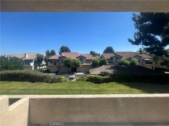 a view of a garden with a building in the background