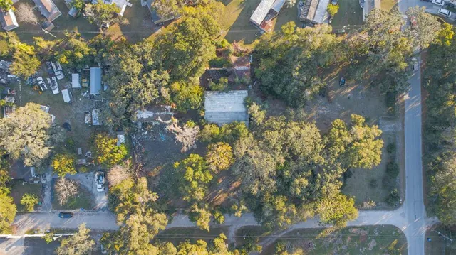 an aerial view of a house with a yard basket ball court and outdoor seating