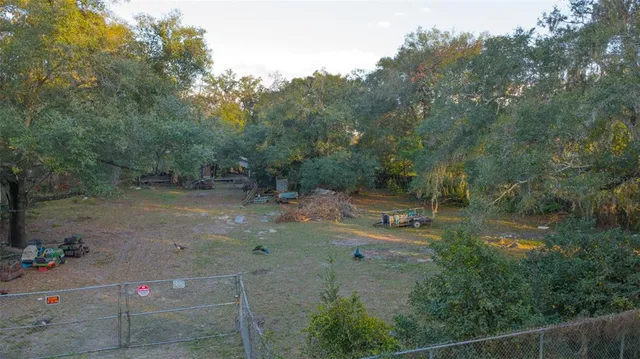 a backyard of a house with a yard and outdoor seating