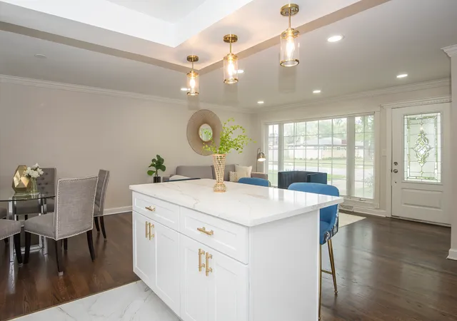 a large kitchen with a table and chairs