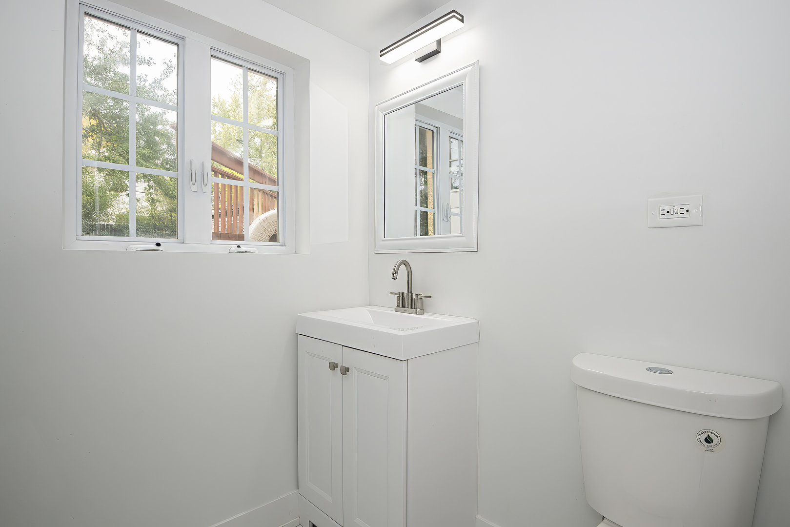 216 Flora Avenue Glenview, IL 60025 - Photo 18 of 40 a bathroom with a sink a toilet and window