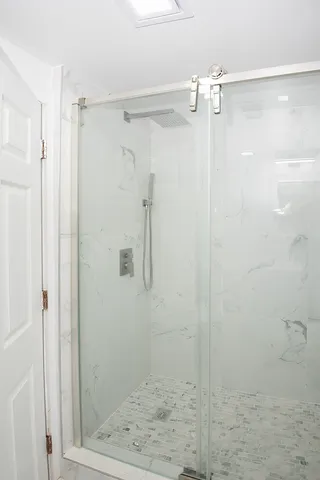 a bathroom with a glass shower door