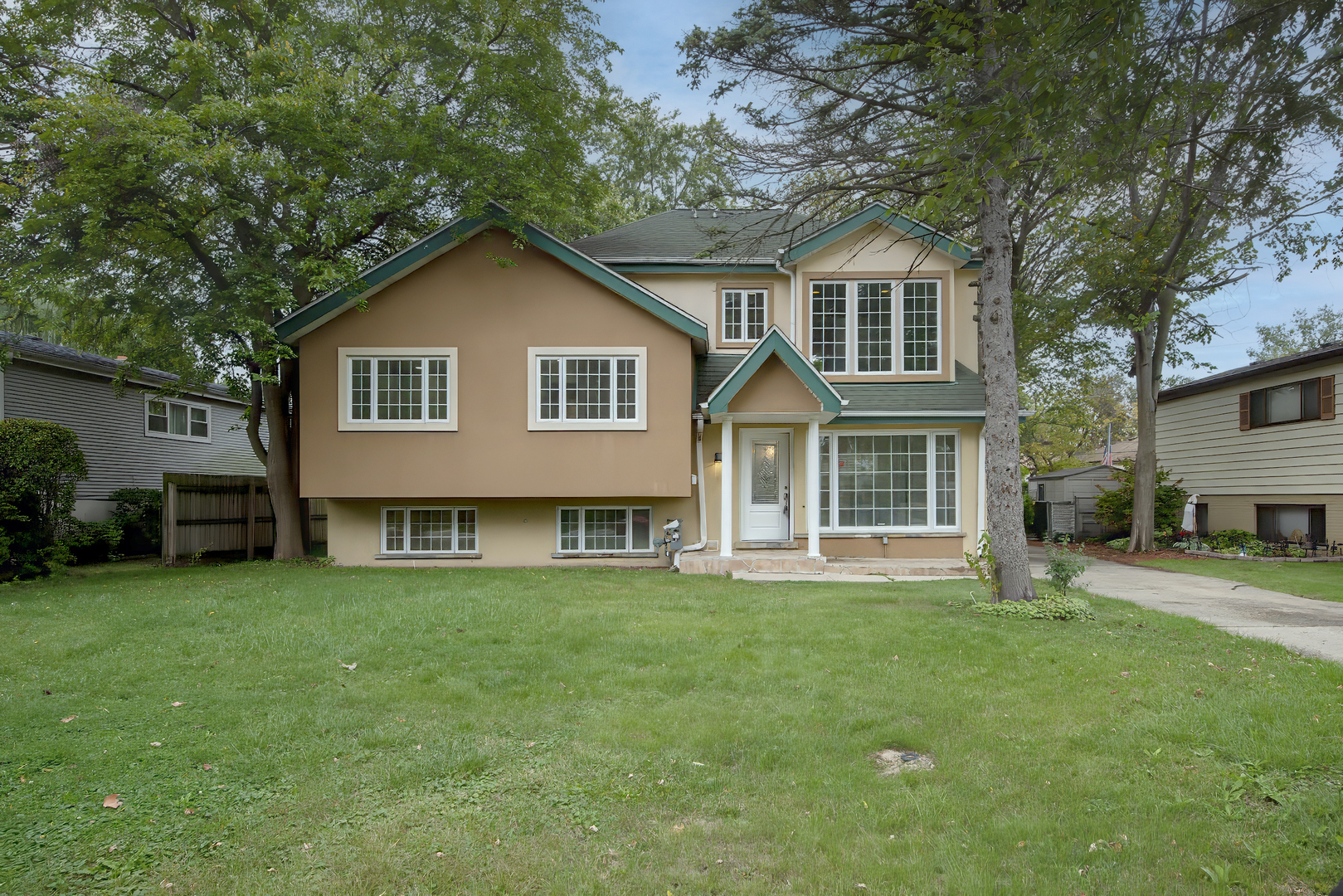 216 Flora Avenue Glenview, IL 60025 - Photo 2 of 40 a front view of a house with a yard and trees