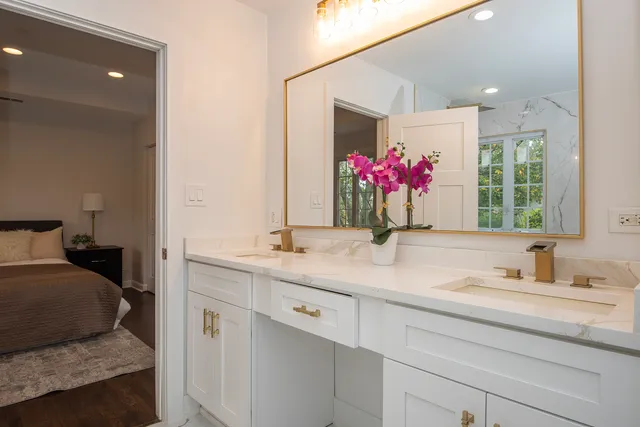 a bathroom with a granite countertop sink and a mirror