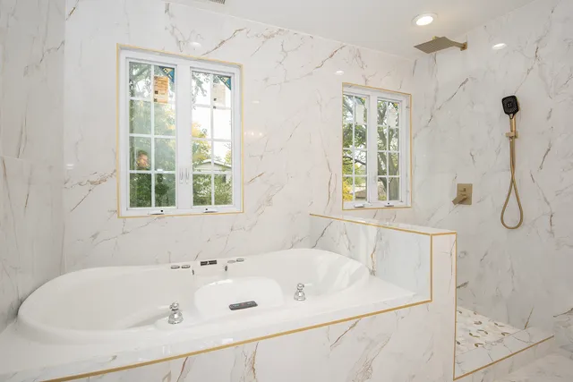 a white bath tub sitting next to a window