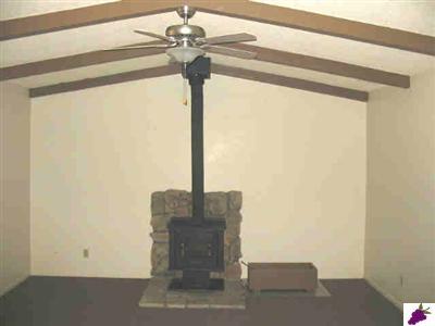 47330 Modoc Road Coarsegold, CA 93614 - Photo 3 of 7 Living room has new carpet, vaulted ceiling, wood stove as well as central heat and air.