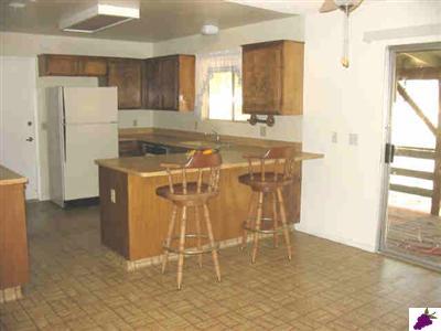 47330 Modoc Road Coarsegold, CA 93614 - Photo 4 of 7 Nice size kitchen with breakfast bar, door to garage, sliders to back deck.