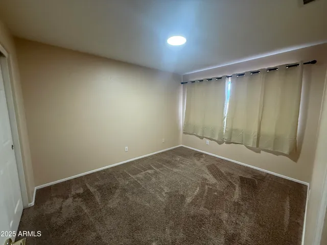 an empty room with closet area