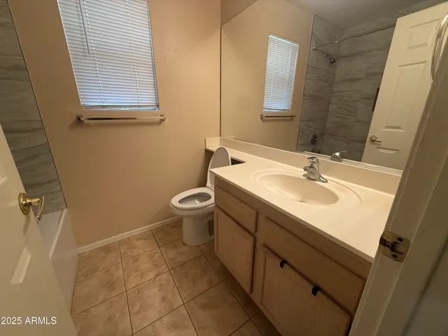 an empty room with a ceiling fan and a window