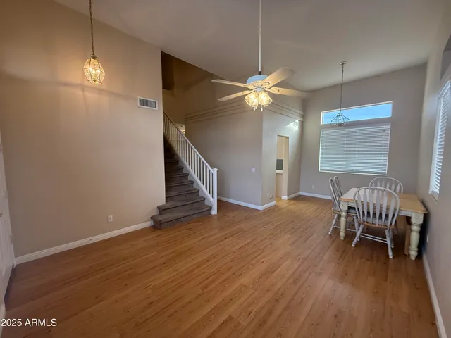 a view of a room with wooden floor and lounge chair