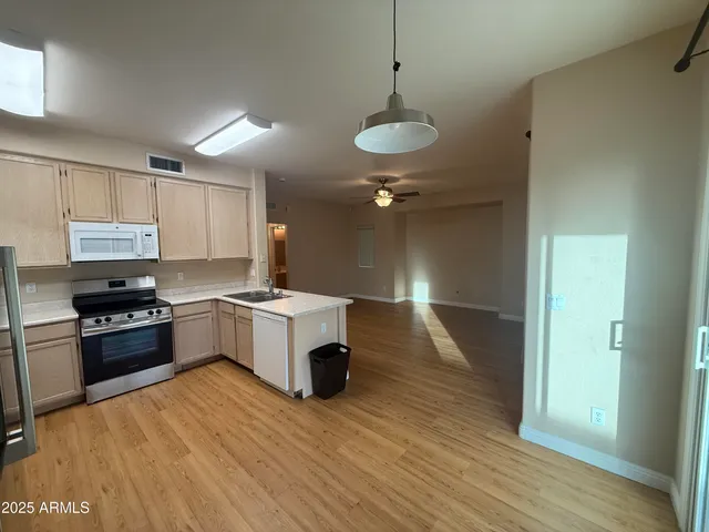a view of a kitchen with a sink and a refrigerator