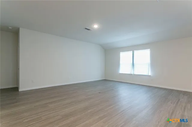 a kitchen with a sink cabinets and wooden floor