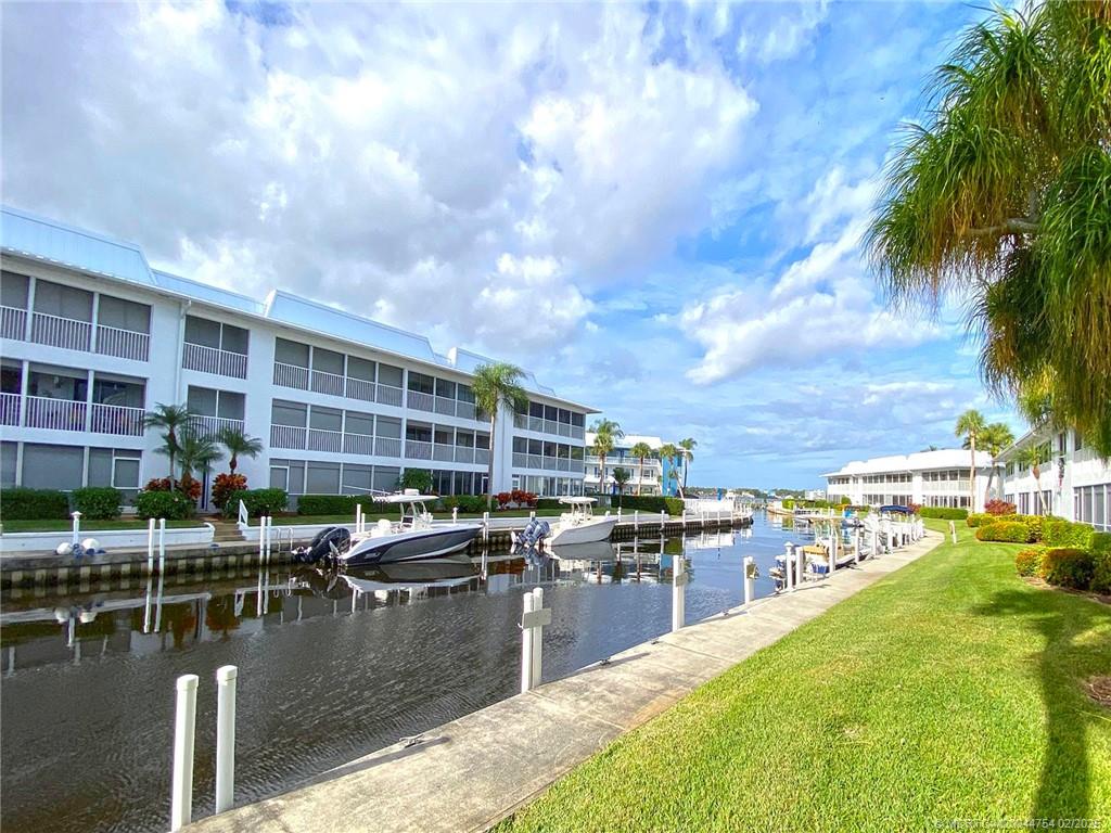1858 Southwest Palm City Road, Unit 203 Stuart, FL 34994 - Photo 1 of 29 a view of a swimming pool with outdoor seating