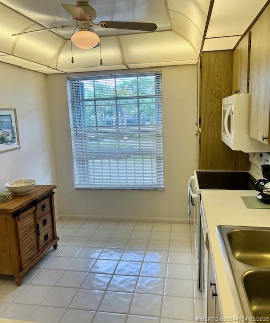 1858 Southwest Palm City Road, Unit 203 Stuart, FL 34994 - Photo 11 of 29 a kitchen with a sink a stove and a microwave