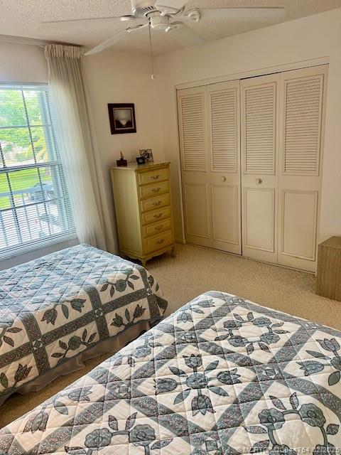 1858 Southwest Palm City Road, Unit 203 Stuart, FL 34994 - Photo 14 of 29 a bedroom with a bed and a window