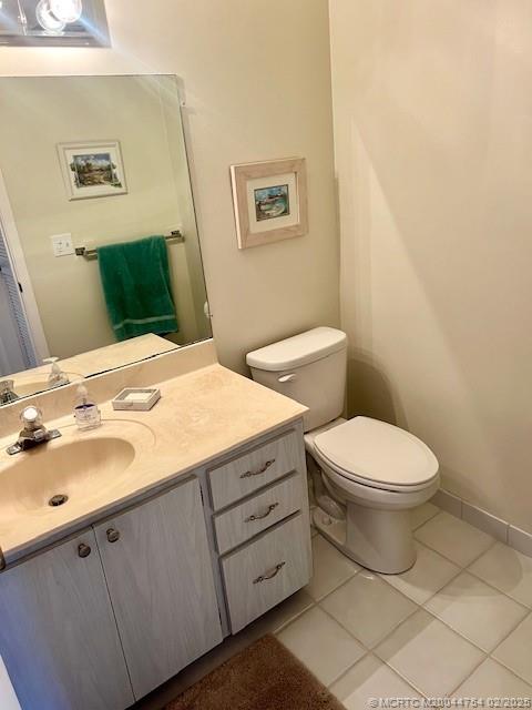 1858 Southwest Palm City Road, Unit 203 Stuart, FL 34994 - Photo 15 of 29 a bathroom with a toilet sink and mirror