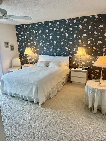 a bedroom with a bed and a large mirror