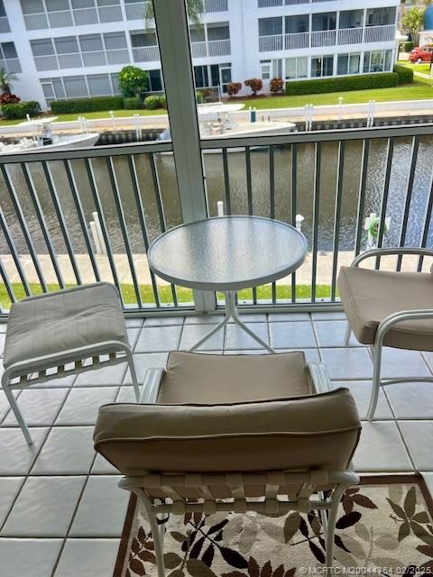1858 Southwest Palm City Road, Unit 203 Stuart, FL 34994 - Photo 28 of 29 a backyard of a house with table and chairs