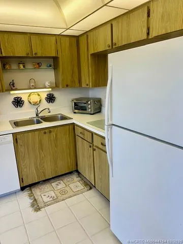 a kitchen with a refrigerator and a more cabinets