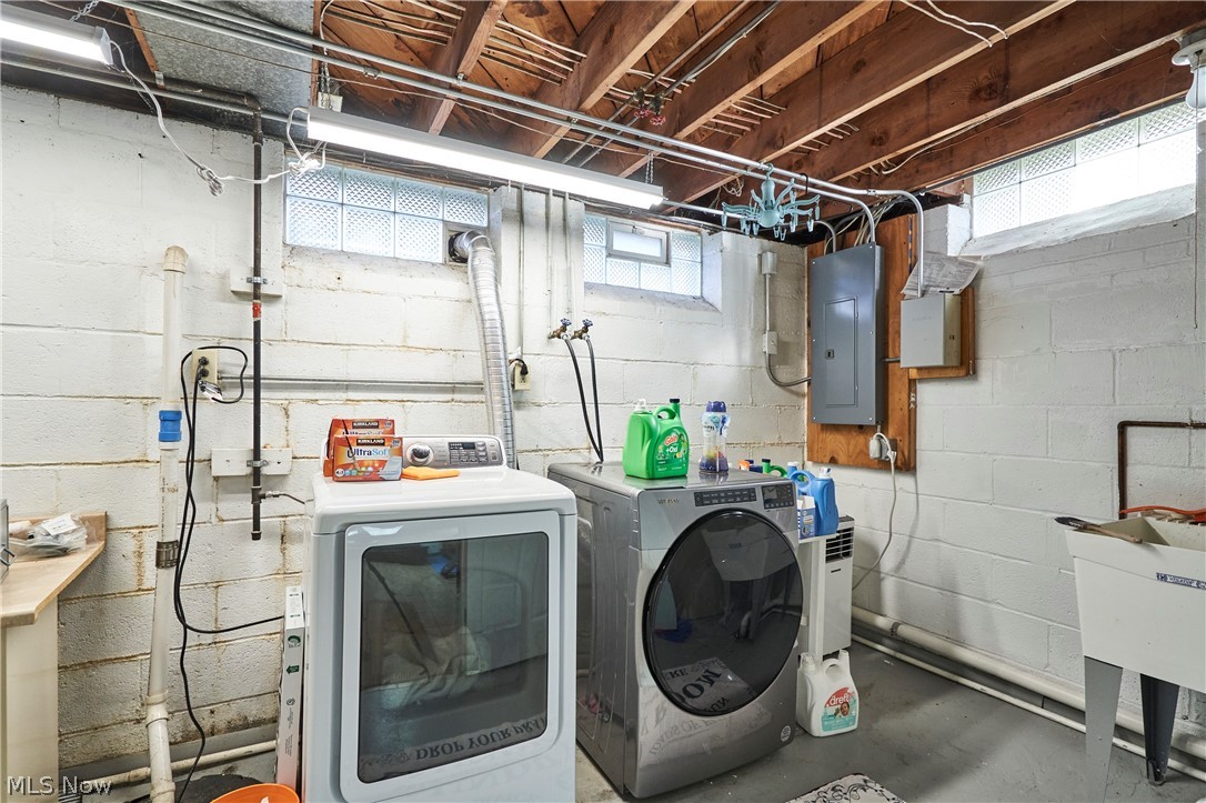 1359 Beaconfield Road Lyndhurst, OH 44124 - Photo 18 of 26 Laundry area featuring concrete flooring, washing machine and clothes dryer, and electric panel