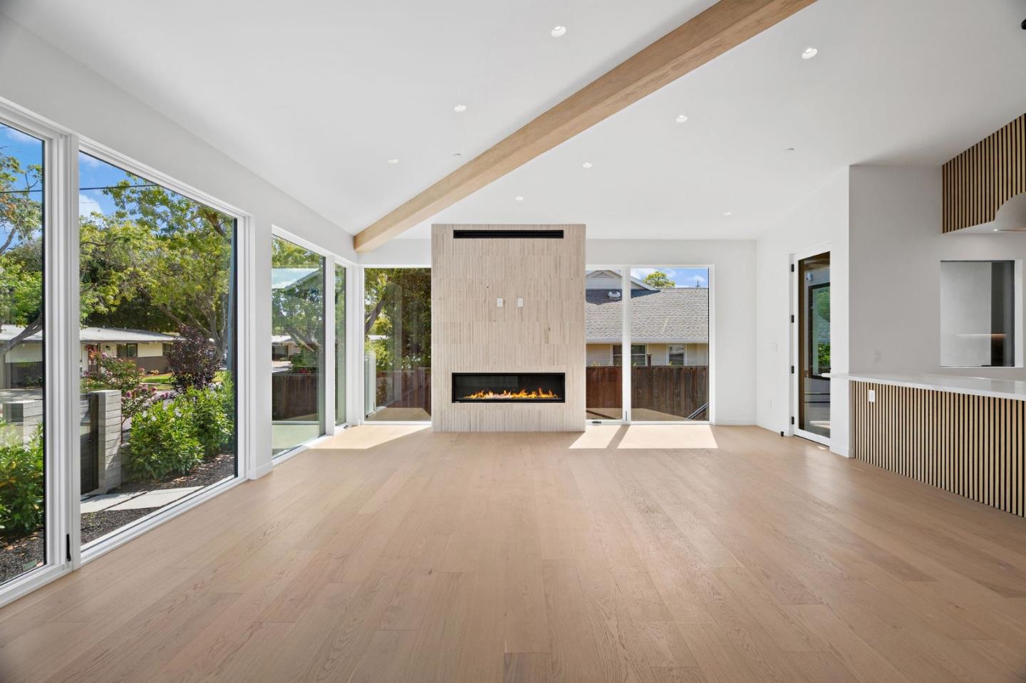 3886 Ross Road Palo Alto, CA 94303 - Photo 18 of 60 a view of a livingroom with wooden floor a fireplace and window