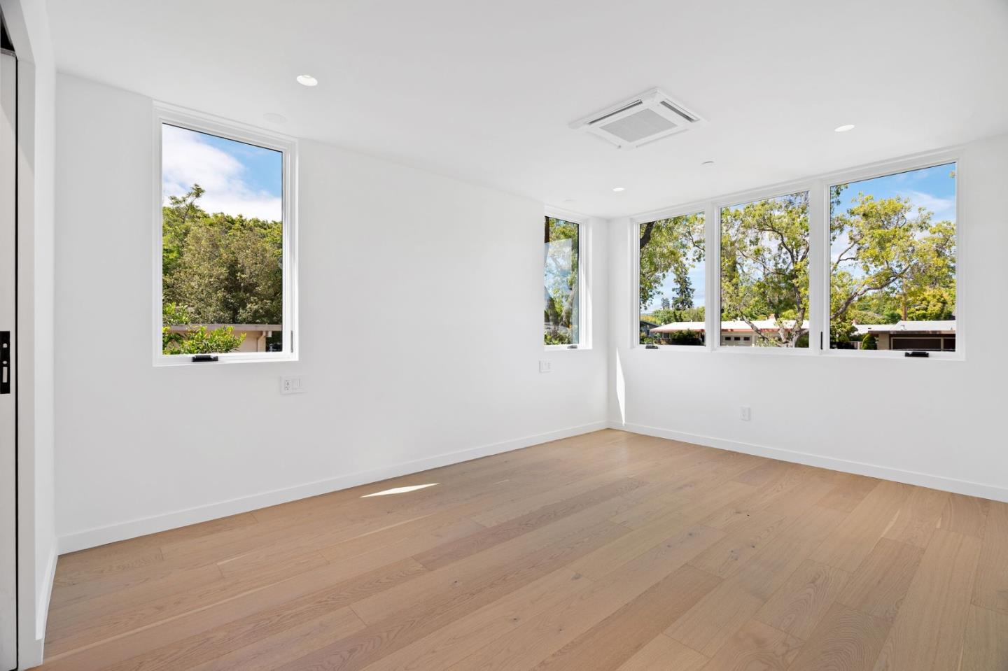 3886 Ross Road Palo Alto, CA 94303 - Photo 22 of 60 an empty room with wooden floor and windows